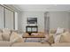 Living room has comfortable seating, wood coffee table, stylish decor, and leads to outdoor living through sliding glass door at 1027 Timbervale Trl, Clermont, FL 34715