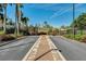 Wide view of parking lot with green landscaping and seating areas with umbrellas at 1027 Timbervale Trl, Clermont, FL 34715