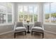 Bright sitting area featuring a large window with plantation shutters and neutral decor at 1027 Timbervale Trl, Clermont, FL 34715