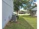 Exterior view of the side yard with green grass and a partial view of a nearby lake at 1033 N Jacks Lake Rd, Clermont, FL 34711