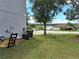 Exterior view of the side yard showing the property, grass and a partial view of a nearby lake at 1033 N Jacks Lake Rd, Clermont, FL 34711