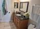 Bathroom featuring a wood vanity with dark countertop and double mirrors at 1033 N Jacks Lake Rd, Clermont, FL 34711