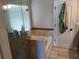 Bright bathroom with a glass-enclosed shower/tub combo with tile surround and neutral flooring at 1033 N Jacks Lake Rd, Clermont, FL 34711