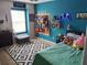 Bedroom features an accent wall and is decorated with a gamer theme at 1033 N Jacks Lake Rd, Clermont, FL 34711