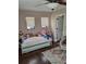 Bedroom featuring a daybed with stuffed animals, wood floors, and neutral paint at 1033 N Jacks Lake Rd, Clermont, FL 34711