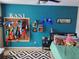The bedroom is decorated with a playful theme and features a mounted Nerf gun rack display on a turquoise wall at 1033 N Jacks Lake Rd, Clermont, FL 34711