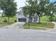 Charming two-story home with well-maintained landscaping and a gray two-car garage at 1033 N Jacks Lake Rd, Clermont, FL 34711