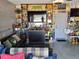 Finished garage area decorated with lots of Packers memorabilia, a couch, and storage at 1033 N Jacks Lake Rd, Clermont, FL 34711