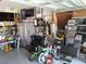 Garage with epoxied floor showing home gym equipment, tv and sports-themed décor at 1033 N Jacks Lake Rd, Clermont, FL 34711