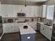 Modern kitchen featuring white cabinets, an island, and stainless steel appliances at 1033 N Jacks Lake Rd, Clermont, FL 34711