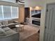 Comfortable living area with cozy seating, fireplace, and large windows with blinds at 1033 N Jacks Lake Rd, Clermont, FL 34711