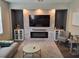 Living room with a stone fireplace, built-ins, and a large windows, creating a cozy ambiance at 1033 N Jacks Lake Rd, Clermont, FL 34711