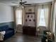 Inviting living room with cozy seating, decorative accents, and natural light from windows with curtains at 1033 N Jacks Lake Rd, Clermont, FL 34711