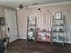 Bright room with wood-look floors, decorative ladder shelves, and inviting front door at 1033 N Jacks Lake Rd, Clermont, FL 34711
