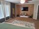 Spacious bedroom with modern decor, an accent wall, and large windows dressed with beautiful curtains at 1033 N Jacks Lake Rd, Clermont, FL 34711
