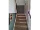 Carpeted staircase with white railing and painted walls adds a welcoming ambiance to the home's interior at 1033 N Jacks Lake Rd, Clermont, FL 34711