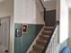 Well-lit staircase with carpeted steps, contrasting wall colors and white trim at 1033 N Jacks Lake Rd, Clermont, FL 34711