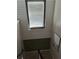 Staircase with a window allowing natural light to illuminate the interior of the house at 1033 N Jacks Lake Rd, Clermont, FL 34711