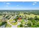 Expansive aerial view of home, showcasing the neighborhood and lush green landscape at 10465 Se 41St Ter, Belleview, FL 34420