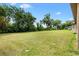 Expansive green backyard showcasing ample space with mature trees, offering privacy and potential for outdoor activities at 10465 Se 41St Ter, Belleview, FL 34420