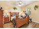 Charming bedroom with wood floors, ceiling fan, and natural lighting at 10465 Se 41St Ter, Belleview, FL 34420