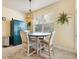 Bright breakfast nook features a round table, natural lighting, and a modern Liberty Safe at 10465 Se 41St Ter, Belleview, FL 34420