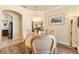 Formal dining area featuring a chandelier, natural lighting, and a decorative painting at 10465 Se 41St Ter, Belleview, FL 34420