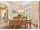 Dining area showcasing a round wooden table, 4 chairs, and a view of the landscape through the window at 10465 Se 41St Ter, Belleview, FL 34420