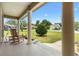 Inviting front porch with classic rocking chairs and columns, offering a peaceful view of the surrounding landscape at 10465 Se 41St Ter, Belleview, FL 34420