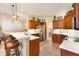Open kitchen features a marble countertop bar, stainless steel appliances, and natural wood cabinets at 10465 Se 41St Ter, Belleview, FL 34420