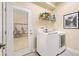 The laundry room has a utility sink, a door to the outside, and a newer washer and dryer at 10465 Se 41St Ter, Belleview, FL 34420