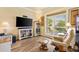 Cozy living room featuring a leather recliner, a large window, and a flat-screen TV at 10465 Se 41St Ter, Belleview, FL 34420