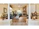 Open-concept living room with a stone fireplace, hardwood floors, and elegant columns with vaulted ceilings at 10465 Se 41St Ter, Belleview, FL 34420