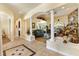 Spacious living area featuring tile flooring, elegant columns, and a clear view into the living room area at 10465 Se 41St Ter, Belleview, FL 34420