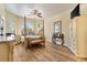Spacious main bedroom featuring a four-poster bed, wood floors, and plenty of natural light at 10465 Se 41St Ter, Belleview, FL 34420
