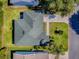 Aerial view outlining property lines, highlighting roof, driveway, landscaping and proximity at 1060 Davenport Dr, The Villages, FL 32162
