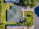 Aerial view of the property highlighting the roof, driveway and landscaping at 1060 Davenport Dr, The Villages, FL 32162