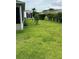 A beautiful backyard features lush green grass and mature landscaping at 1060 Davenport Dr, The Villages, FL 32162