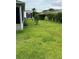 A beautiful backyard features lush green grass and mature landscaping at 1060 Davenport Dr, The Villages, FL 32162