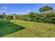 Backyard with a green lawn and neatly trimmed shrubbery and hedges at 1060 Davenport Dr, The Villages, FL 32162