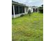 An expansive backyard features lush green grass and mature landscaping at 1060 Davenport Dr, The Villages, FL 32162