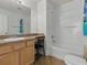 Bright bathroom featuring a vanity, mirror, and a shower-tub combo at 1060 Davenport Dr, The Villages, FL 32162