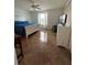 Bright bedroom with a queen-sized bed, dresser, ceiling fan, and natural light at 1060 Davenport Dr, The Villages, FL 32162
