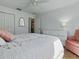 Inviting bedroom featuring a comfortable bed, nightstand, and dresser, with an accent chair at 1060 Davenport Dr, The Villages, FL 32162