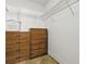 Walk-in closet with wire shelving and wood drawers providing ample storage space at 1060 Davenport Dr, The Villages, FL 32162