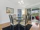 Cozy dining area near the kitchen, featuring stylish furnishings, a glass table, and sliding door access at 1060 Davenport Dr, The Villages, FL 32162