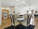 Open-concept dining area with glass table, seating for four, and modern finishes at 1060 Davenport Dr, The Villages, FL 32162