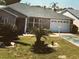 Charming single-story home with a well-manicured lawn and attached one-car garage at 1060 Davenport Dr, The Villages, FL 32162