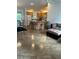 Open kitchen with island, seating, wood cabinets, and view into dining and living areas at 1060 Davenport Dr, The Villages, FL 32162