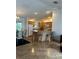 Open kitchen with a large island and seating, plus wood cabinets at 1060 Davenport Dr, The Villages, FL 32162